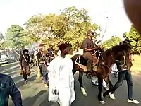 Agworok youth leader on horseback approaching.
