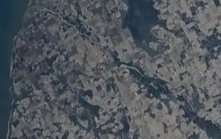 The Ahnapee River on February 7, 2022, taken from the International Space Station. The source of the river (lower right) is at the southeast of Gardner Swamp. The millpond at Forestville (center) appears as a long white spot. The river flows southwest towards its mouth at Algoma (upper left).