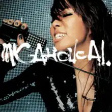 A close-up shot of Ai, smiling with her eyes closed, holding a microphone stand. She is wearing a low-cut black shiny dress, and is standing against a dark blue and black patterned background. In front of her is the title, MIC-A-HOLIC A.I., written in graffiti style white handwriting.