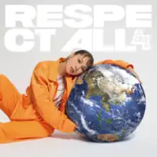 Ai is seen slightly laying on the ground wearing an orange jacket and pants with a white shirt underneath. Around her hands is a globe of Earth, her head slightly resting on it. Behind her is the title of the album and artist's name in bright white lettering