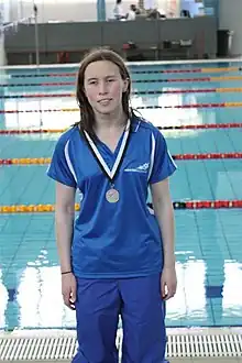 Aine with a medal at the pool for the 2011 Para Swimming National Championships