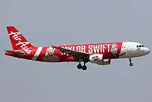 An airplane with the text "TAYLOR SWIFT" and headshots of her on its livery.