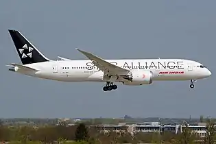 An Air India Boeing 787-8 Dreamliner in Star Alliance livery on final approach to London Heathrow Airport.