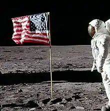 Cropped photo taken a few seconds later. Buzz Aldrin's hand is down, head turned toward the camera, the flag is unchanged.