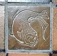 A bronze tiles with a reliefs of a fish