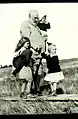 Alexander Graham Bell relaxing on Beinn Bhreagh with three of his granddaughters.