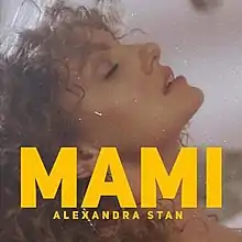 Shot of Stan with curled hair; the song's title is superimposed on her.