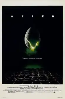 A large egg-shaped object that is cracked and emits a yellowish light hovers in mid-air against a black background and above a waffle-like floor. The title "ALIEN" appears in block letters above the egg, and just below it, the tagline appears in smaller type: "In space no one can hear you scream."