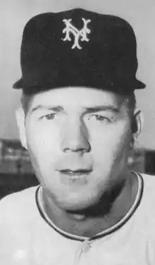 A man in a white baseball jersey and a dark cap with "NY" on the center.