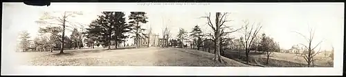 Black and white blurry photo shows Allegheny College campus in 1909 in winter with trees with no leaves