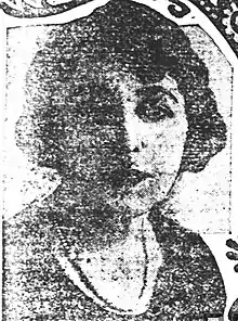 A grainy newspaper photo of a white woman with dark bobbed hair.