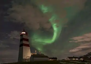 Alnes lighthouse at night with Northern lights