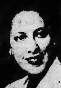 A black-and-white photograph of a Black woman's smiling face