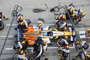 mechanics change tyres and refuel a race car