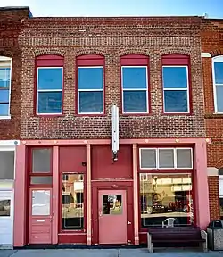 A red-colored storefront along a street in New Franklin, Missouri