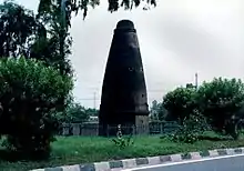 A stone pillar close to a road