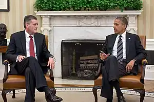 US Ambassador Rick Olson with President Barack Obama, in the Oval office, with guttae on the Ionic fireplace.