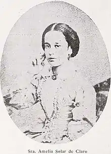 B&W oval portrait of a woman with hair in an up-do, wearing a pale-colored dress.