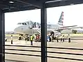 An American Airlines A319 (N833AW) parked at the platform.