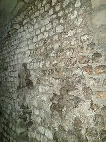 Photograph showing the inside west wall of the main vomitorium of the amphitheatre. The junction between the original wall and the expanded section can be seen by change in coloration