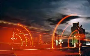 Photo shot with a Bulb exposure. The movement of the clouds, crossing arms and passing train register as streaks rather than sharp images, unlike the stationary objects in the frame.