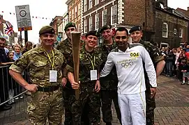 One British soldier wearing a Multi-Terrain Pattern uniform, left, and other soldiers wearing temperate versions of Disruptive Pattern Material uniform.