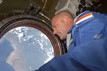 Dutch ESA astronaut André Kuipers looks out of the Destiny nadir window at Earth