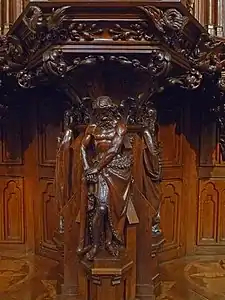 The sculpture of Adam supporting the pulpit