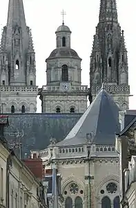 The bell tower, center, topped with the cross of Anjou