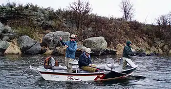 Anglers fly fishing drift boat