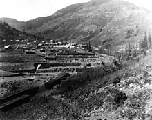 View of the Silverton Northern Railroad's trackage just below Animas Forks, Erection of the Gold Prince Mill and the town is seen in the distance.