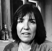 black and white headshot of Commire - a white woman with shoulder length dark hair