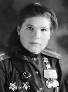 Portrait photograph of Antonina Khudyakova in uniform wearing her Hero of the Soviet Union medal, Two Orders of the Red Banner, Two Orders of the Patriotic War, Guards pin, and campaign medals