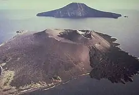 Aerial view of volcanic island with another, rocky island in the background