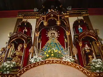 Image of Our Lady of Salambáo in the altar of Obando Church, flanked by St Paschal to her right and St Clare to her left.