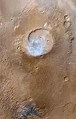 False-color Mars Global Surveyor image of Apollinaris Mons. White clouds can be seen hovering above the volcano.