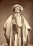 Arab man smoking pipe, late 1800s.