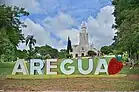 The main church in Areguá and its welcome sign