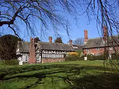 Brick terraced building and Tudor or Tudor-revival timber-framed building