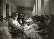 Armenian refugees from Turkey carding wool in Tiflis, Georgia. Photograph by Melville Chater from the National Geographic Magazine, 1920.