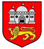 A shield with a red background. A white castle is in the top of the shield, while a yellow lion is on the bottom.