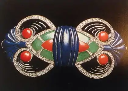 A gold buckle set with diamonds and carved onyx, lapis lazuli, jade, and coral, by Boucheron (1925)