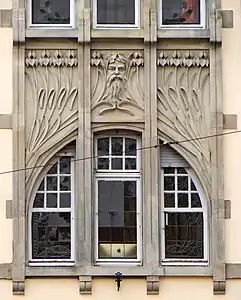 Irises and mascaron at the façade of Schichtel building by Aloys Walter in Strasbourg, France (1905–06)