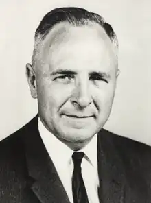 Black and white photo of Potter in a suit and tie