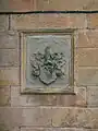 The Dunlop family Coat of Arms on the wall of the house.