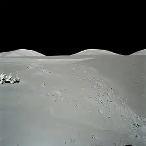 Exploring Shorty crater during the Apollo 17 mission to the Moon.  The orange soil was found to the right of the rover, at the base of the small hill at the crater rim.