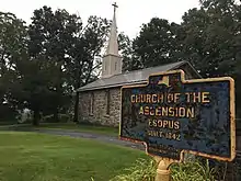 a picture of the marker with the church behind it