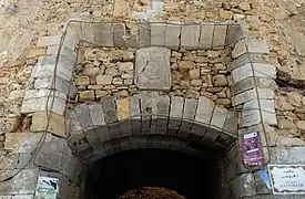 Portuguese coat of arms still visible above Bab Homar gateway.
