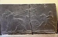Assyrian chariot, charioteer, and a horse rider. Basalt wall reliefs from the palace of Tiglath-pileser III at Arslan Tash, Syria. 744-727 BCE. Ancient Orient Museum, Istanbul