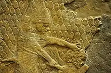 Relief depicting an Assyrian soldier about to behead a man